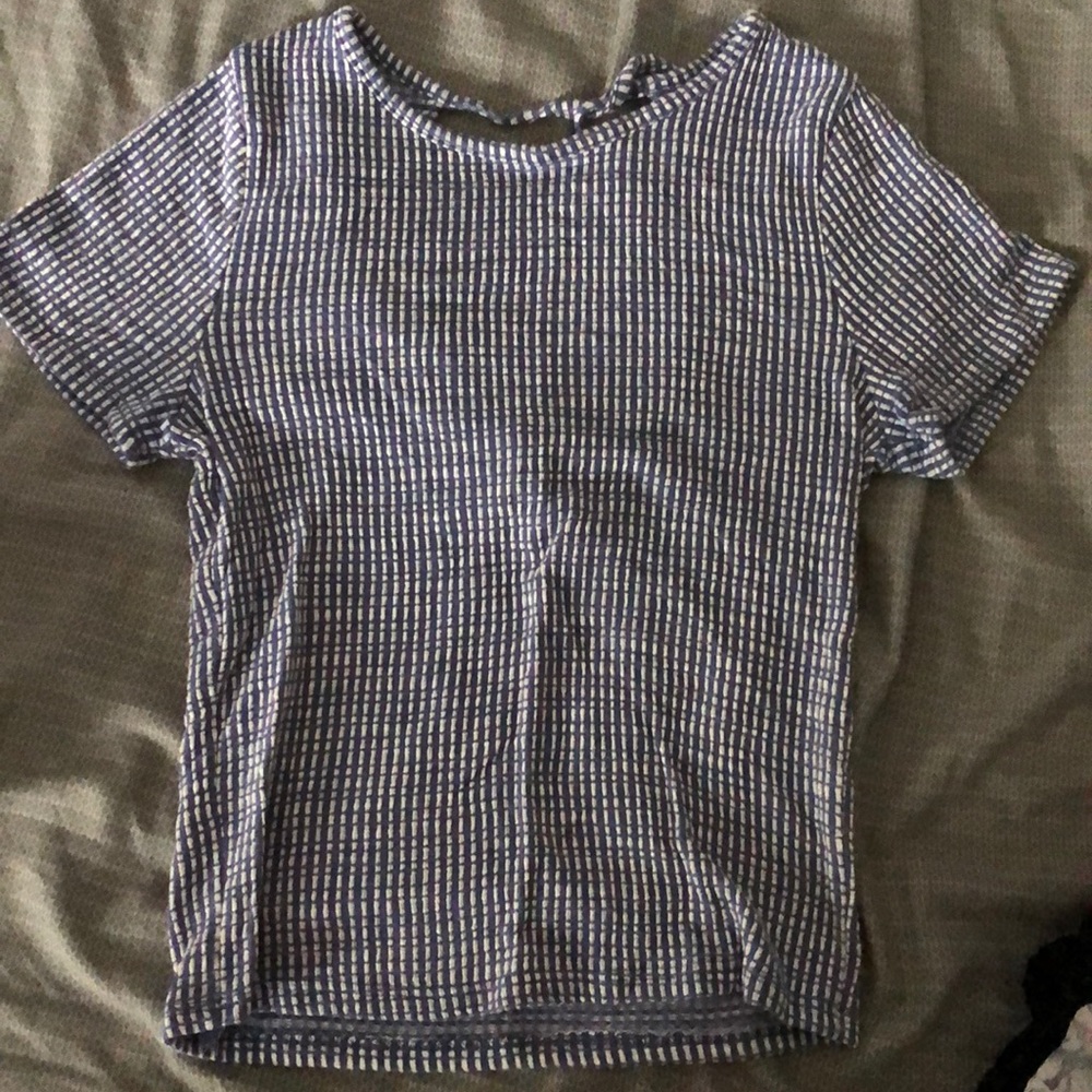 Caution to the wind, tight-fitted, short sleeve shirt.